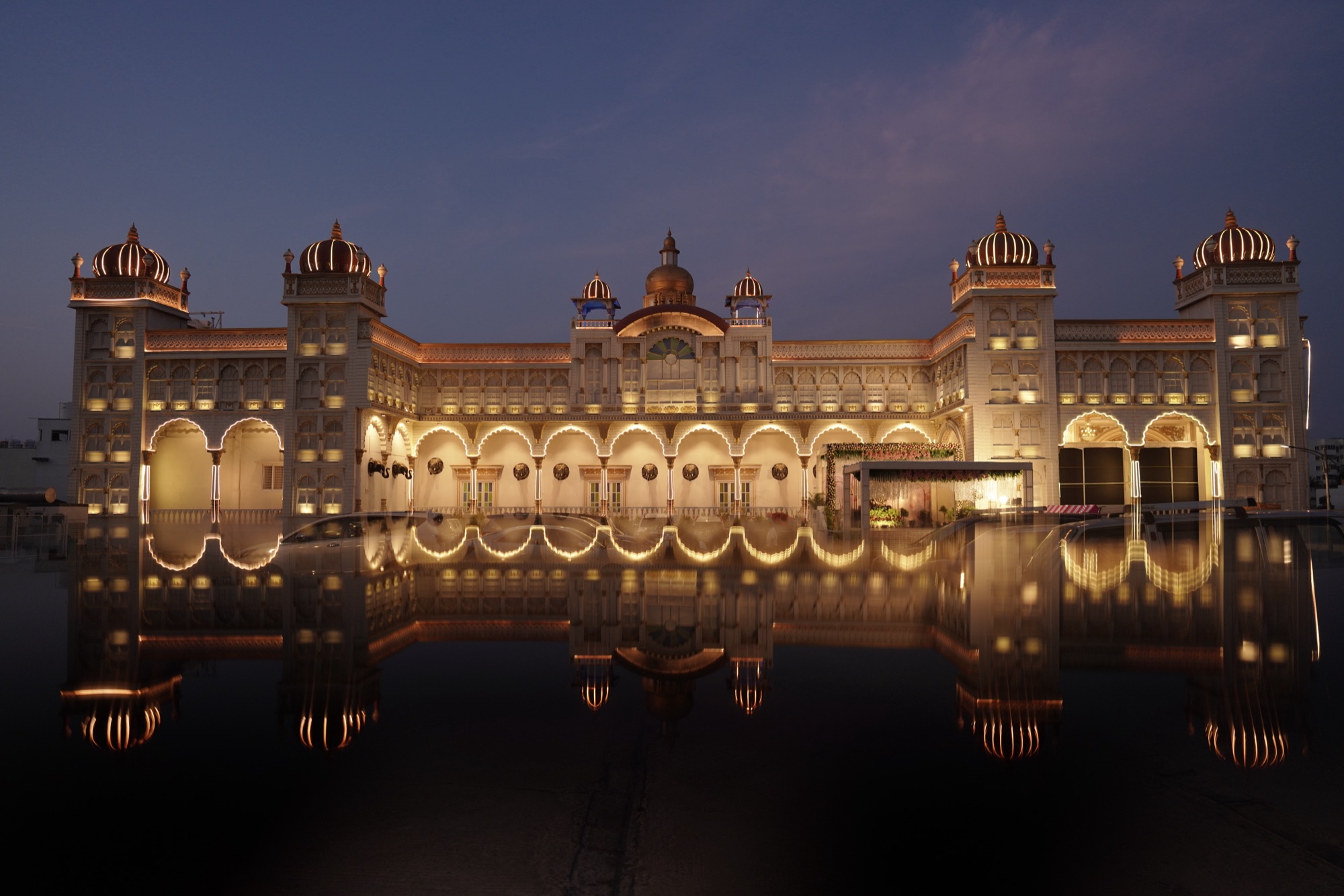 Illuminated palace wedding venue at dusk